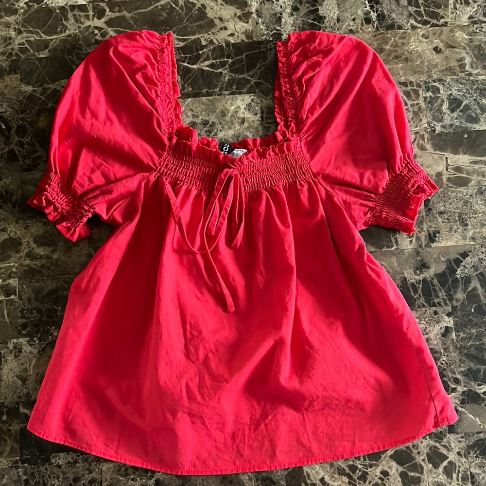 A red shirt with puffy sleeves